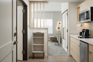 a kitchen with a door leading to a living room at TownePlace Suites by Marriott Chattanooga South, East Ridge in Chattanooga