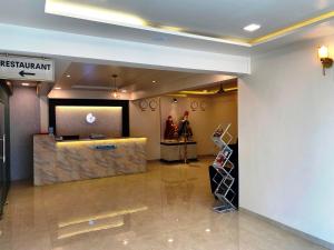 a lobby of a hotel with a reception desk at The Grand Sarovar Inn And Suites in Chakan