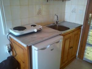 a kitchen with a sink and a counter top at Sofos Apartments in Tsilivi