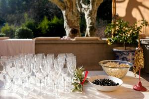 a group of wine glasses on a table at Bastide provençale avec piscine in Brignoles