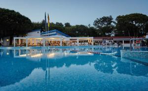 a large swimming pool in front of a building at Dei Fiori Camping Village in Cavallino-Treporti