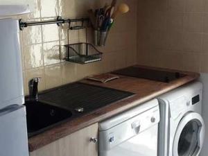 a kitchen with a sink and a washing machine at Maison Valras-Plage, 3 pièces, 6 personnes - FR-1-781-6 in Valras-Plage
