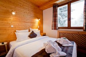 a bedroom with a bed with towels on it at Hotel les Flocons in Courchevel