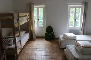 a room with two bunk beds and a green monster chair at Bastide provençale avec piscine in Brignoles
