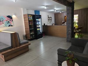 a waiting room with couches and a drink cooler at Bella Augusta Hotel in Sao Paulo