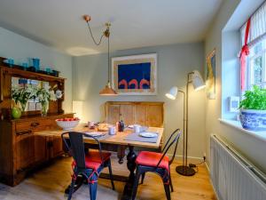 a dining room with a wooden table and chairs at 1 Bed in Beaulieu 78926 in Beaulieu