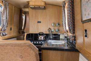 a kitchen with a sink and a stove at Wren Class at Gayton Marina in Northampton