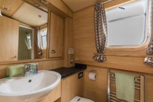 a bathroom with a sink and a toilet at Wren Class at Gayton Marina in Northampton