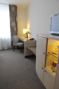 Postel nebo postele na pokoji v ubytování Sachsenpark-Hotel