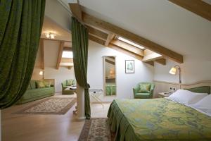 a bedroom with a bed and a living room at Hotel Luis in Fiera di Primiero