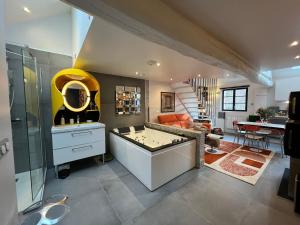 a living room with a foos ball in the middle at Aux Quatre Petits clos in Jouars-Pontchartrain