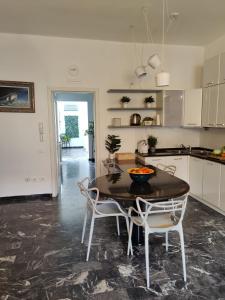 a kitchen and dining room with a table and chairs at Casa Stella in Viareggio