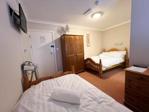 A bed or beds in a room at The Exchange Hotel