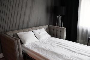 a bed with two pillows on it in a bedroom at Vimmerby Stadshotell, WorldHotels Crafted in Vimmerby