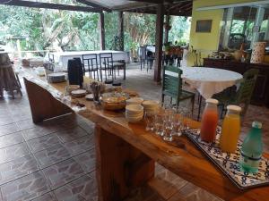 una gran mesa de madera con comida y bebidas. en Toca do Roka, en Socorro