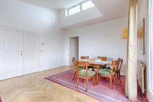 - une salle à manger avec une table et des chaises dans l'établissement Résidor - Apartment 4P La Villette Park, à Paris
