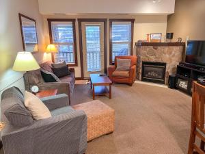 a living room with a couch and a fireplace at Silver Rock Condominiums by Fernie Central Reservations in Fernie