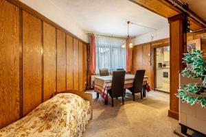 a bedroom with a table and chairs and a dining room at Ferienwohnung im Harz in Harzgerode