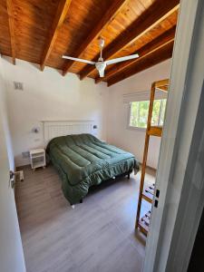 a bedroom with a bed and a ceiling fan at La mansa del pinar in La Lucila del Mar +15 photos