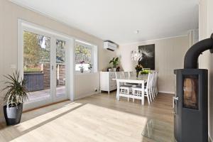 a living room with a fireplace and a dining room at Fint hus i Flåm in Aurland +11 photos