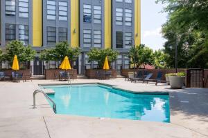 a swimming pool in front of a building at Spacious 2BD with Private Balcony and Free Parking in Charlotte