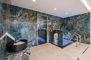 a bathroom with a shower and a bath tub at Tavel Hotel & SPA in Bukovel