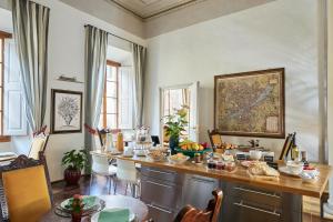 a dining room with a table with food on it at Peruzzi Urban Residences in Florence