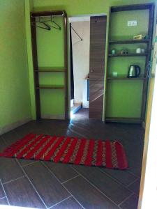 a room with a red rug on the floor next to a closet at Riad Bouganville Bleu in Marrakesh