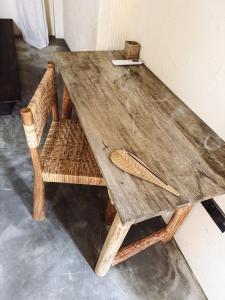 a wooden table with two chairs and a wooden spoon at AMMA Boutique Hotel in Ahangama +17 photos