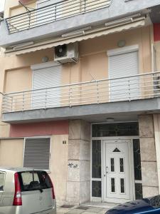a building with a balcony and a door with a fan at GIAZITZI in Xanthi