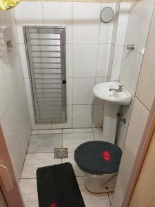 a small bathroom with a toilet and a sink at Studio Centro in Porto Alegre