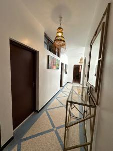 a hallway with a glass table and a door at Sea Surf and Sun in Tamraght Ouzdar