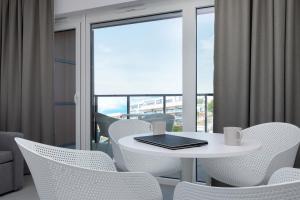 a white table and chairs with a laptop on it at Aquamarina Prima 049 by Renters in Międzyzdroje