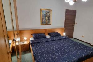 a bedroom with a bed with a blue comforter at Holiday home in Lokve, Croatia 47707 in Lokve
