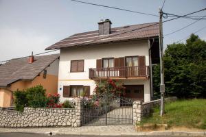 a house with a stone fence in front of it at Holiday home in Lokve, Croatia 47707 in Lokve