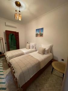 a bedroom with two beds in a room at Riad Amalia in Marrakech