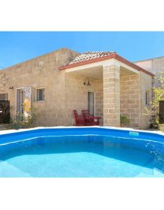 a large swimming pool in front of a house at Dimora Cavalieri charming house salento puglia in Andrano