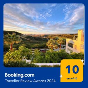 a sign that reads travel review awards with a picture of a house at Superior apartment for golf, sea and nature lovers in Casares
