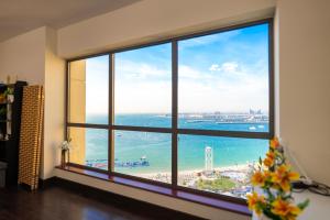 a room with a large window with a view of the ocean at Nirvana Home in Dubai