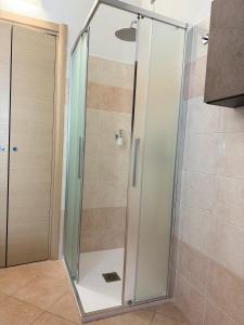 a shower with a glass door in a bathroom at Sweet Home in Lissone