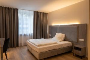 - une chambre avec un lit et une grande fenêtre dans l'établissement Diamonds Hotel, à Cologne