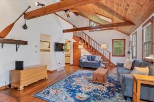 a living room with a blue couch and a rug at Enjoy Brewster With Years Of Family Charm in Brewster