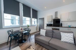 a living room with a couch and a table at One Bedroom Apartments in Liverpool City Centre in Liverpool