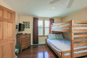 a bedroom with a bunk bed and a dresser at Stay On The Cape Vacation Rentals: Book Eastham Plenty Of Room For Entire Family in Eastham