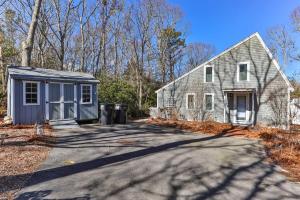 a house with a shed next to a driveway at Stay On The Cape Vacation Rentals: Contemporary Saltbox In New Seabury in Mashpee
