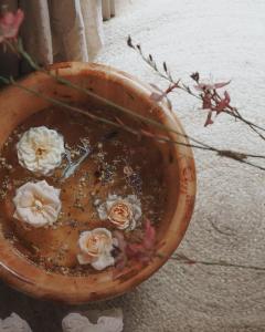 a wooden bowl with white flowers in it at The Shepherd's Purse in Whitby
