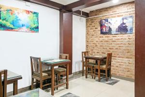 a room with two tables and chairs and a brick wall at City Star Hotel & Restaurant in Jawāharnagar