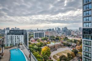 a view of the city from the balcony of a building at RivetStays - The Jarvis in Toronto