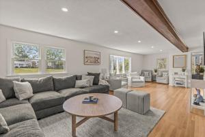 a living room with a couch and a table at Stay On The Cape Vacation Rentals: Immaculate Home 2 Acres Short Walk To Beach in Bourne
