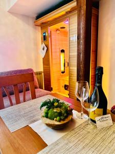 a table with a plate of food and a bottle of wine at Tatry PANORAMA apartmány Tatragolf B-F in Veľká Lomnica